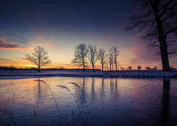 A beautiful frozen pond in the rural scene during the morning golden hour. 