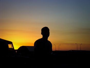 Silhouette man against sky during sunset