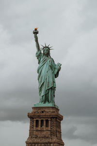 Low angle view of statue against cloudy sky