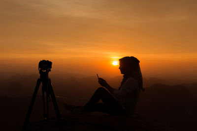 Silhouette of people at sunset