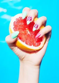Close-up of woman hand holding citrus fruit