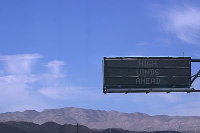 Warning sign against mountains