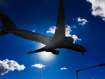 Low angle view of airplane flying in sky