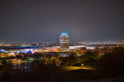 Illuminated buildings against sky at night