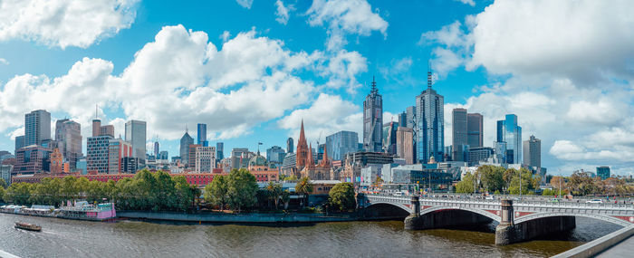 Panoramic view of bridge and buildings against sky