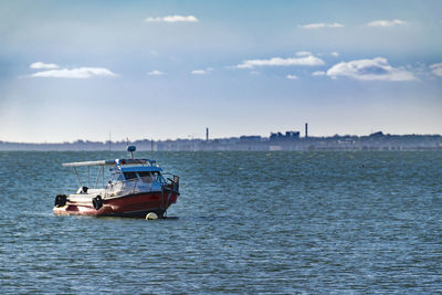 Boat sailing in sea against sky