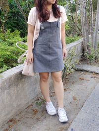 Full length of a woman standing against plants