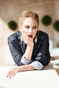Portrait of a young woman sitting outdoors