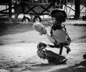 Full length of baseball catcher on field