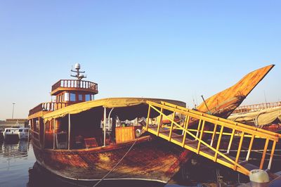 Ship moored in water against clear sky