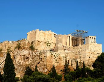 Low angle view of historic building against blue sky