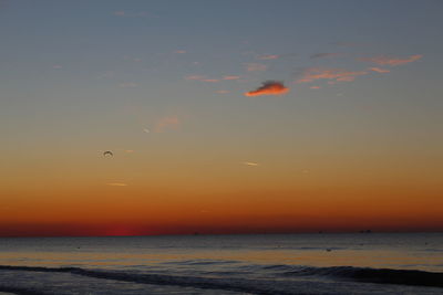 Scenic view of sea against orange sky
