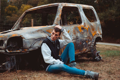 Full length of man sitting in car