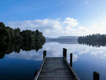 Scenic view of pier over lake against sky