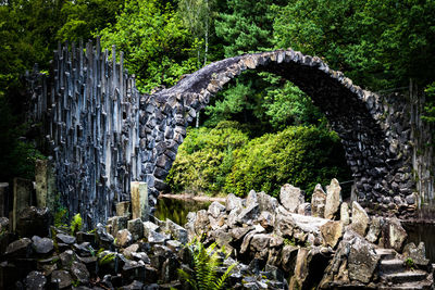 View of bridge over rocks in forest