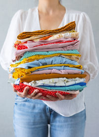 Midsection of woman standing against white background