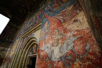 Low angle view of multi colored ceiling of historic building