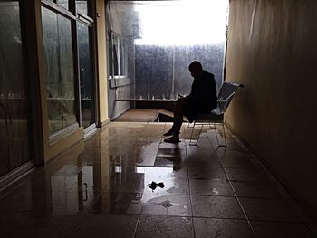 Rear view of a woman standing on floor