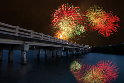 Fireworks over bridge over hickory pass leading to the ocean in bonita springs, florida.