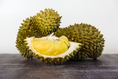 Close-up of fruit on table against white background