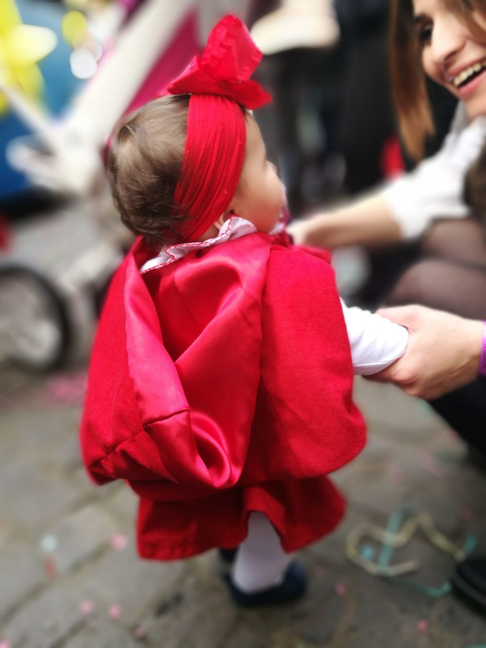 CLOSE-UP OF RED MAN WITH UMBRELLA