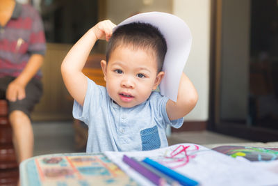 Boy drawing on table at home