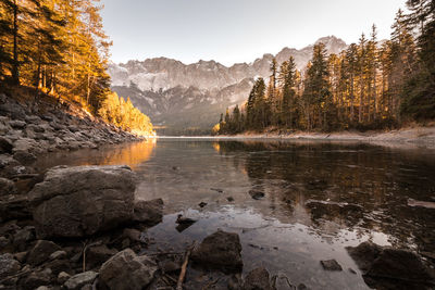 Scenic view of lake against mountains amidst trees