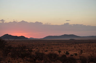 Scenic view of mountains against sky at sunset