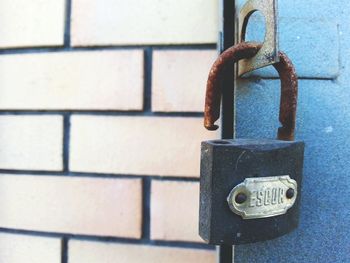 Close-up of padlock against the wall