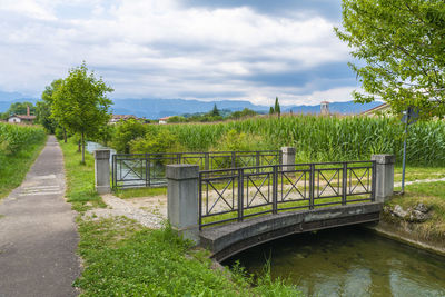 Scenic view of bridge over canal against sky