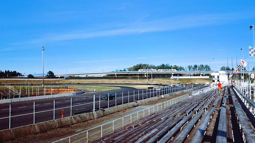 Motor racing track at stadium against sky