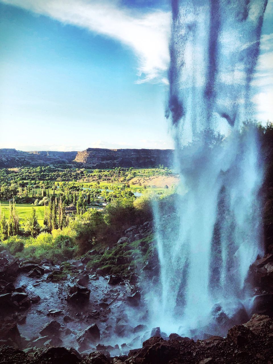 PANORAMIC VIEW OF WATERFALL AGAINST SKY