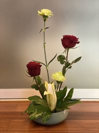 Close-up of red rose in vase on table