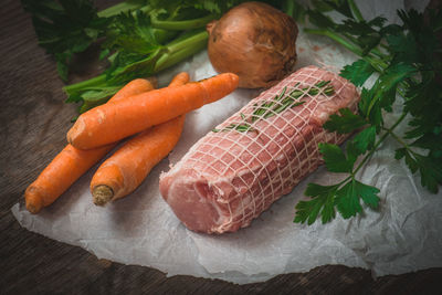 High angle view of vegetables and meat on wooden table