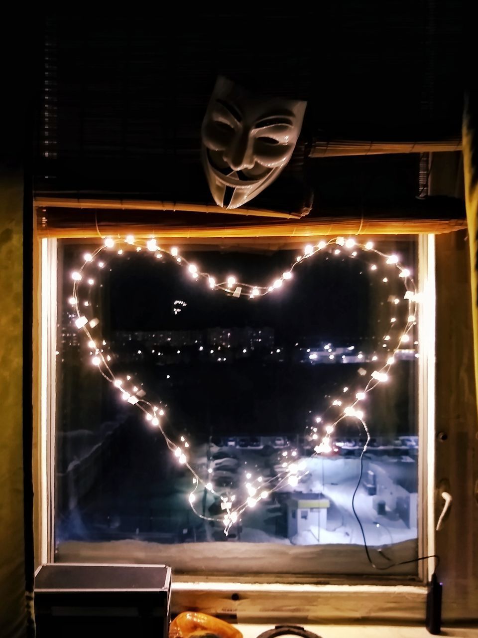 LOW ANGLE VIEW OF ILLUMINATED WINDOW AT RESTAURANT