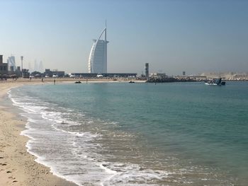 Scenic view of sea and buildings against sky