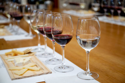 Glass of wine and glasses on table