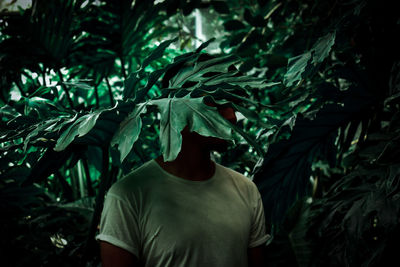 Man standing by plants