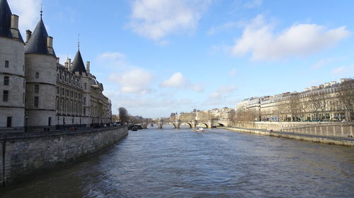 River amidst buildings against sky in city