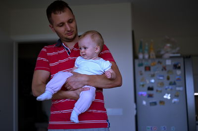 Portrait of siblings playing in home