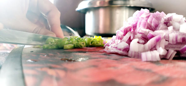 Close-up of woman preparing food on cutting board