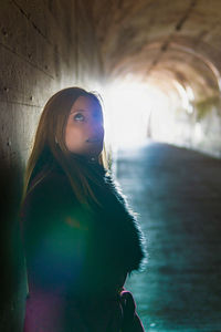 Portrait of woman standing in sunlight
