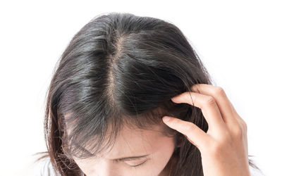 Woman looking away against white background