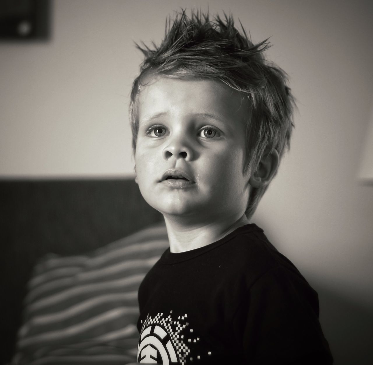 headshot, portrait, person, looking at camera, lifestyles, indoors, focus on foreground, front view, casual clothing, close-up, head and shoulders, leisure activity, contemplation, home interior, young adult, childhood, waist up