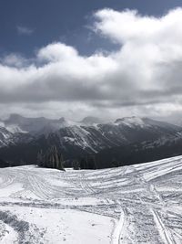 Scenic view of snow covered mountains against sky