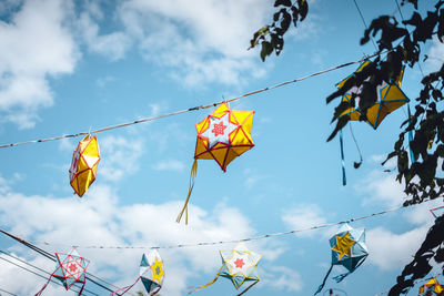 Low angle view of flags against sky