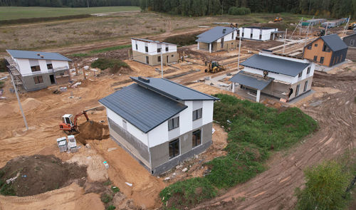 High angle view of houses amidst buildings