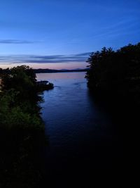 Scenic view of river against sky at sunset