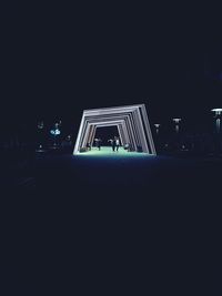 Low angle view of illuminated building against sky at night