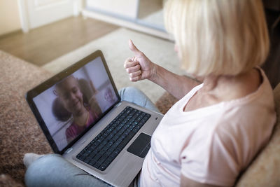 Midsection of woman using digital tablet